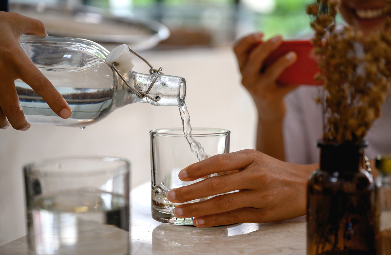 Pouring fresh cold water into a drinking glass